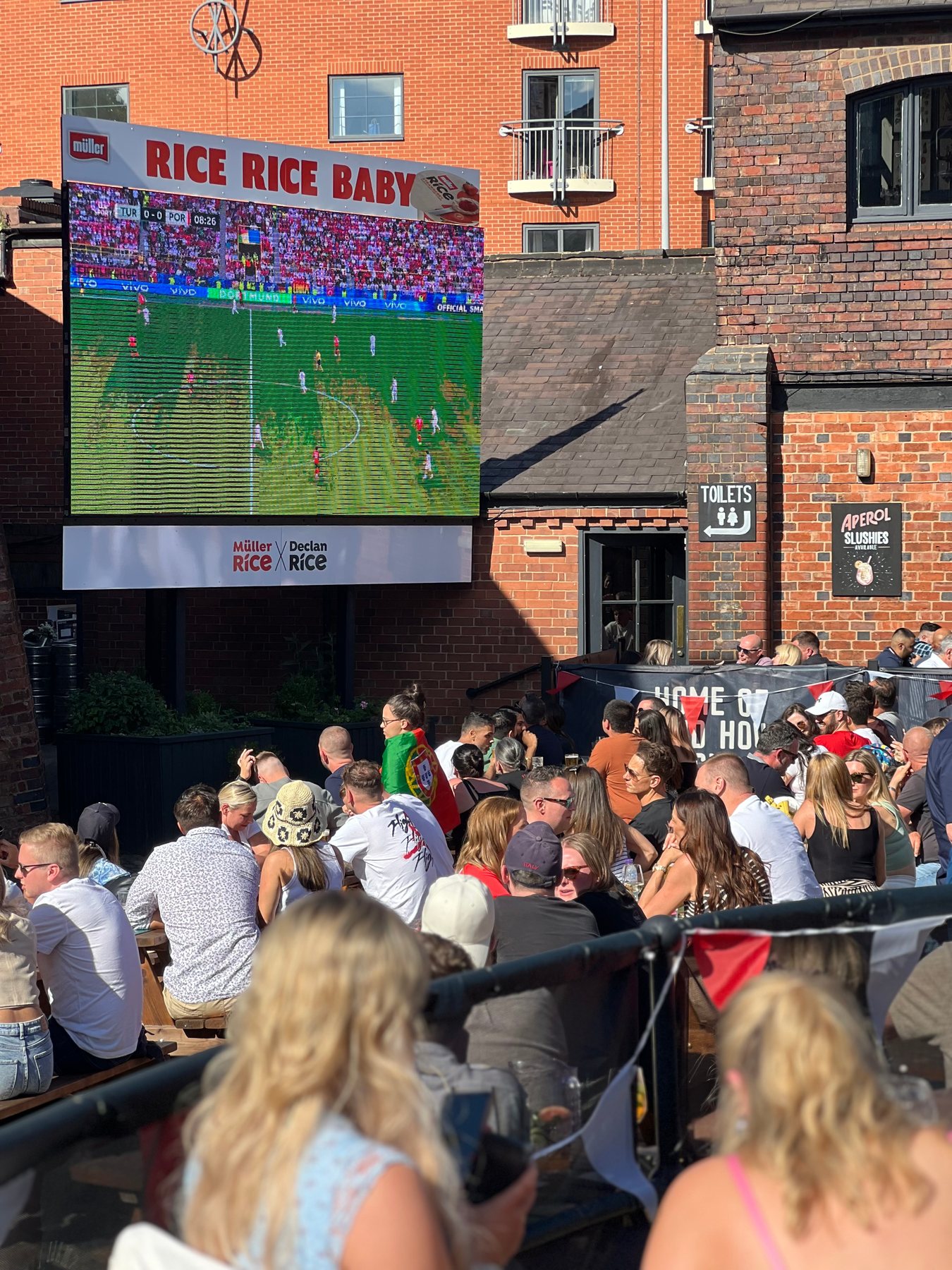 Supporters watching the outdoor screen at The Distillery